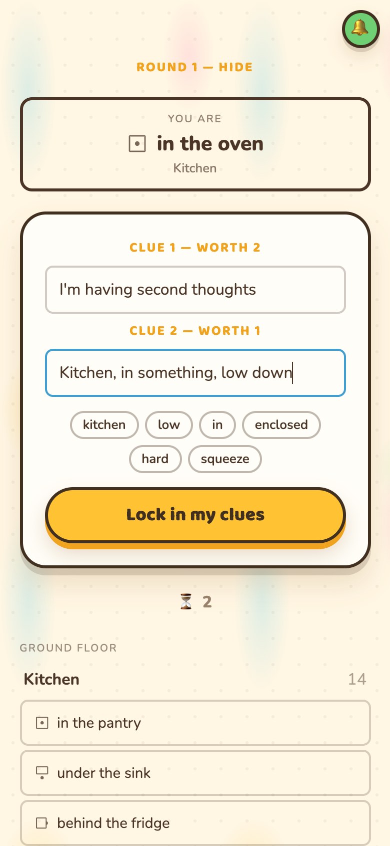 A phone showing 'You are in the oven, Kitchen', two clue boxes labelled 'Clue 1 - worth 2' and 'Clue 2 - worth 1' holding "I'm having second thoughts" and "Kitchen, in something, low down", a row of tappable chips reading kitchen, low, in, enclosed, hard, squeeze, and a 'Lock in my clues' button